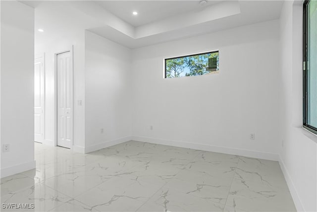 unfurnished room with a raised ceiling