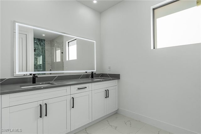 bathroom featuring vanity and a shower with door