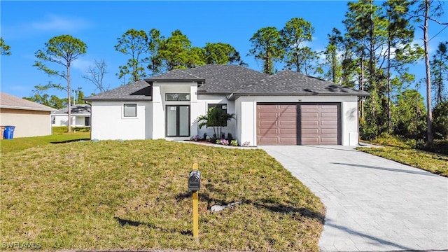 view of front of house featuring a front yard and a garage