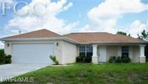 ranch-style home with a garage and a front lawn