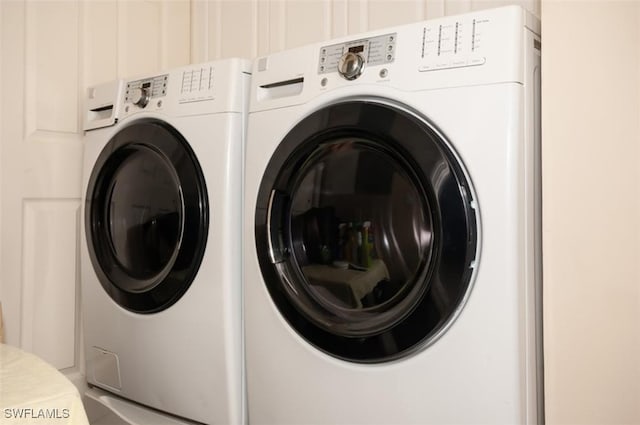 clothes washing area featuring washer and clothes dryer