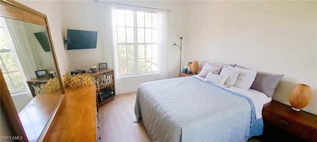 bedroom featuring light hardwood / wood-style floors and multiple windows