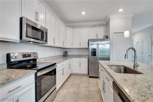 kitchen with a sink, crown molding, stainless steel appliances, and white cabinets