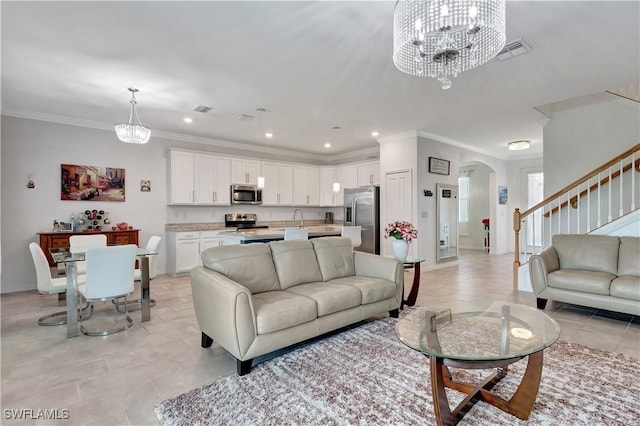 2122 Hamlin St, Naples, FL 34120 - living area featuring a chandelier, arched walkways, light tile patterned flooring, stairs, and crown molding