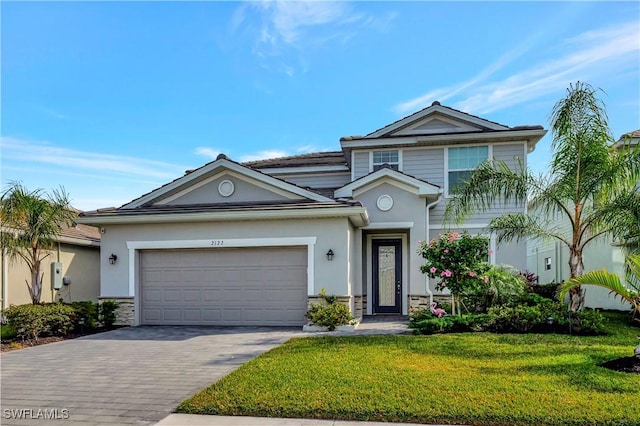 2122 Hamlin St, Naples, FL 34120 - view of front of home featuring stone siding, driveway, a front yard, stucco siding, and a garage