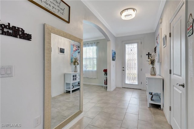 entryway featuring light tile patterned floors and ornamental molding