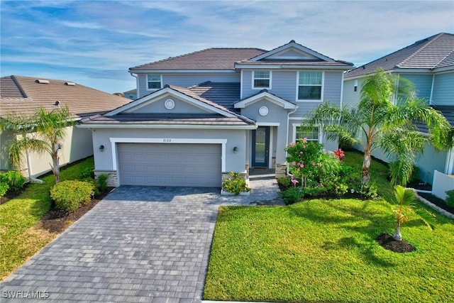 view of front of property with a front lawn and a garage