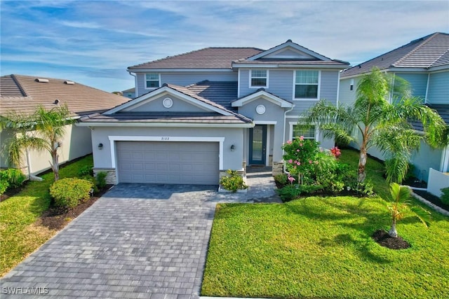 2122 Hamlin St, Naples, FL 34120 - traditional home with a garage, a front lawn, decorative driveway, and stucco siding