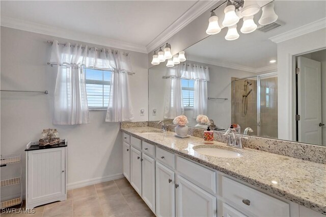 bathroom with tile patterned floors, crown molding, vanity, and a shower with shower door