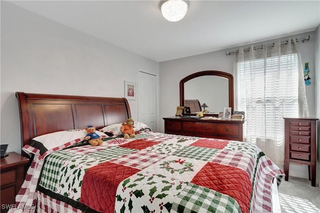 carpeted bedroom featuring a closet