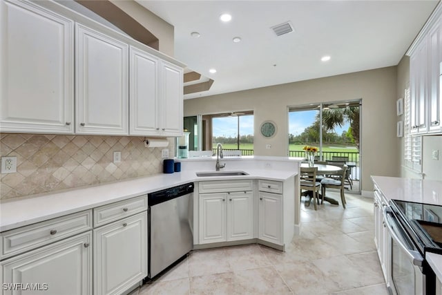 kitchen featuring backsplash, white cabinetry, sink, and appliances with stainless steel finishes