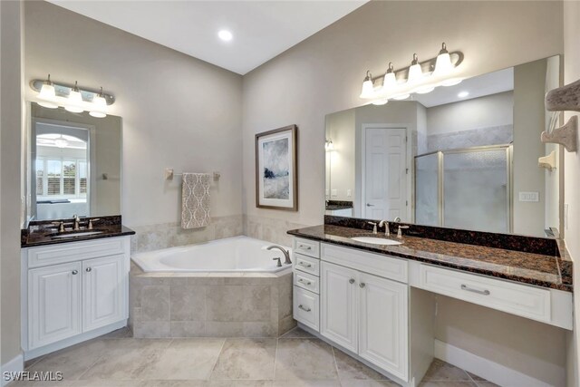 bathroom featuring vanity and independent shower and bath