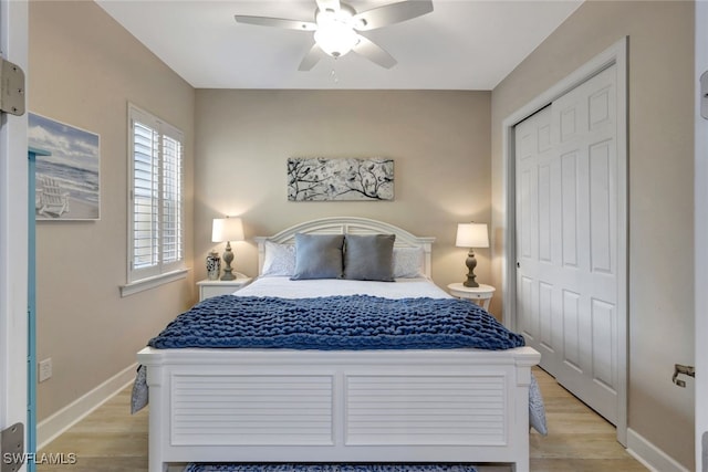 bedroom featuring light hardwood / wood-style flooring, a closet, and ceiling fan