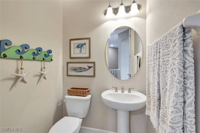 bathroom with toilet and sink