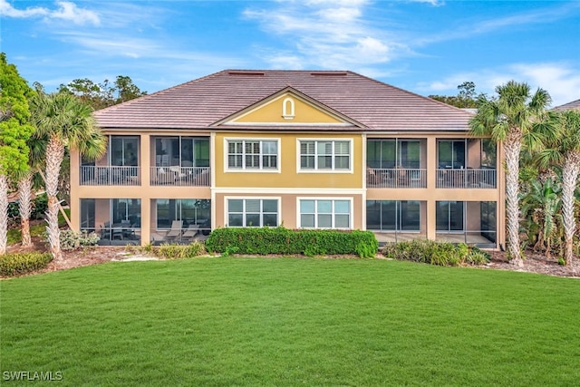 rear view of property with a lawn