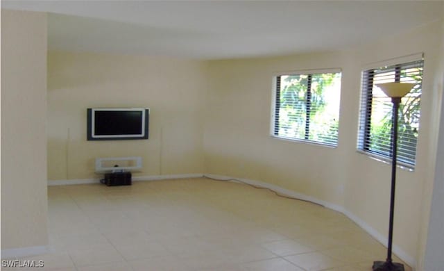 empty room with light tile patterned floors