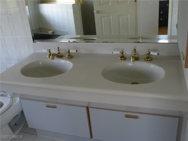 bathroom featuring tile patterned floors, vanity, tasteful backsplash, and toilet