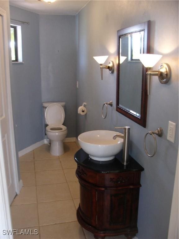 bathroom with tile patterned flooring, vanity, and toilet