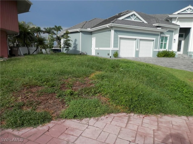 view of home's exterior with a yard and a garage