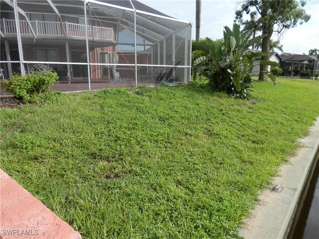 view of yard with glass enclosure