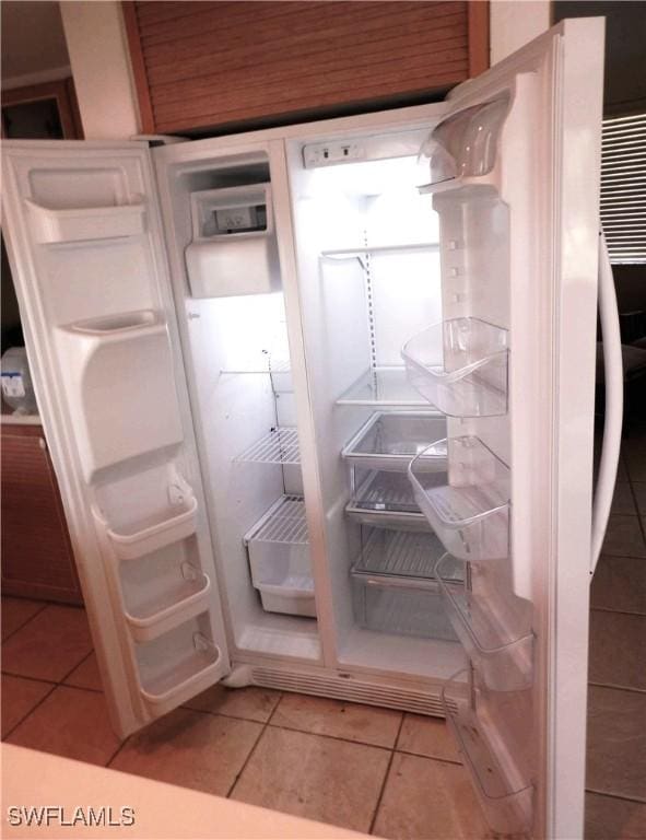 interior details featuring white cabinetry and white fridge with ice dispenser