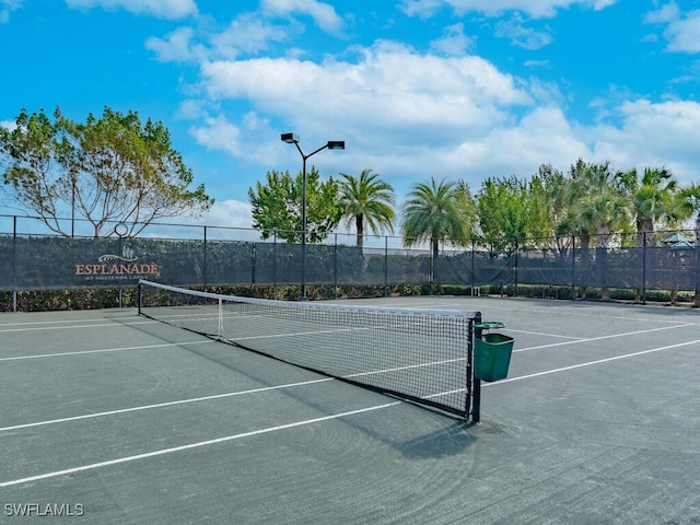 view of tennis court with fence