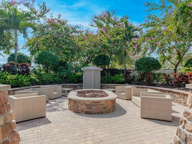 view of patio / terrace with an outdoor living space with a fire pit