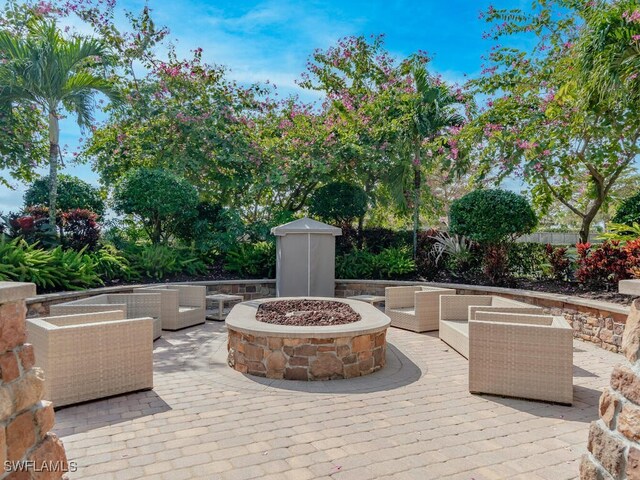 8524 Sevilla Ct, Naples, FL 34114 - view of patio featuring an outdoor living space with a fire pit