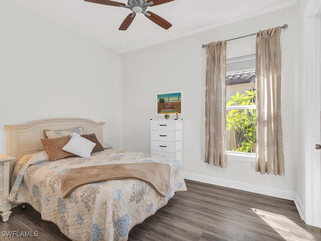 bedroom featuring wood finished floors, a ceiling fan, and baseboards