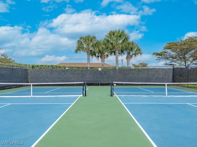 view of sport court featuring fence