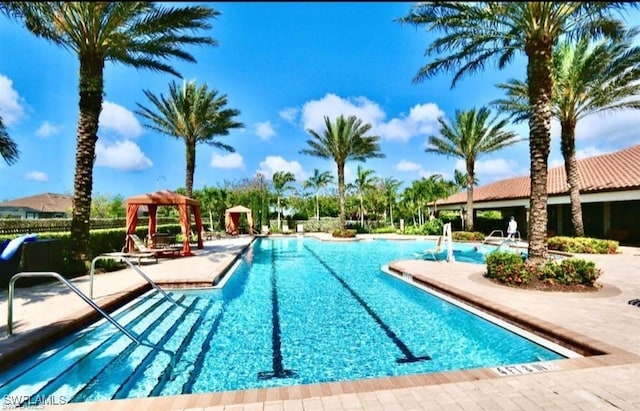 community pool with a patio and a gazebo