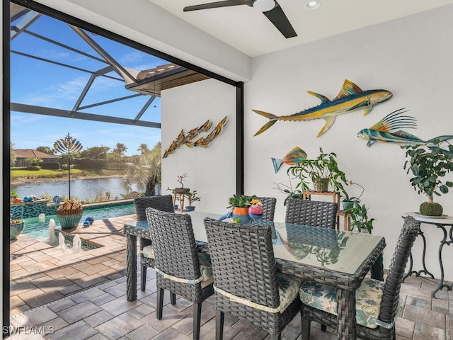 view of patio / terrace with an outdoor pool, a ceiling fan, glass enclosure, a water view, and outdoor dining space