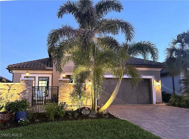 mediterranean / spanish-style home featuring a garage