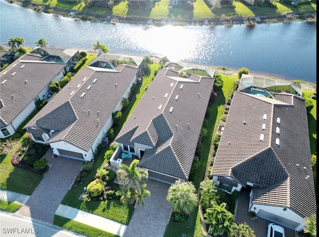 drone / aerial view with a water view and a residential view