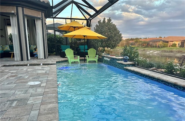 outdoor pool with glass enclosure and a patio area