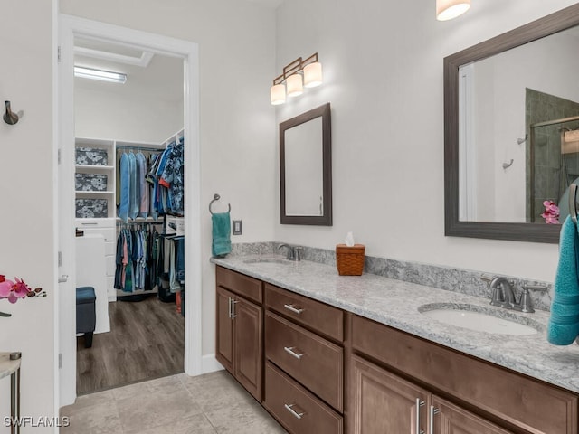 8524 Sevilla Ct, Naples, FL 34114 - bathroom featuring double vanity, a shower stall, a spacious closet, and tile patterned floors