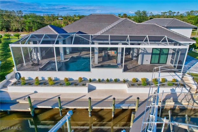 rear view of property featuring a lanai