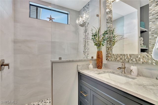 bathroom with vanity and tiled shower