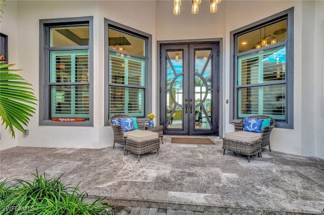 property entrance featuring a patio area and french doors