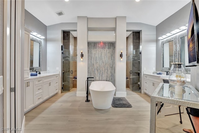 bathroom featuring lofted ceiling, shower with separate bathtub, hardwood / wood-style floors, and vanity