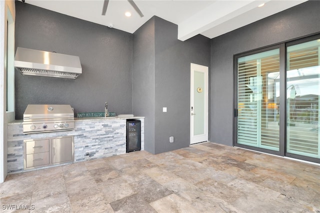 view of patio featuring area for grilling, sink, beverage cooler, and an outdoor kitchen