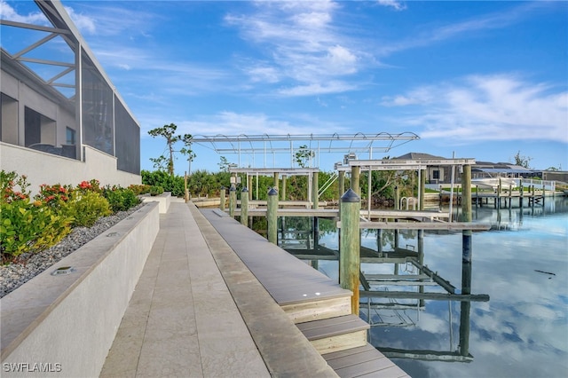 dock area with glass enclosure and a water view