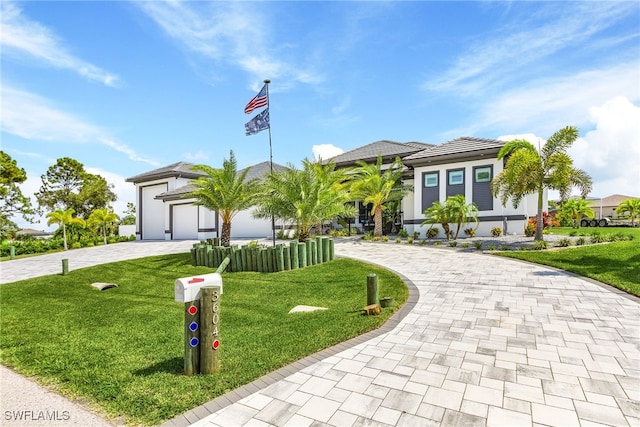 view of front of home featuring a garage and a front lawn