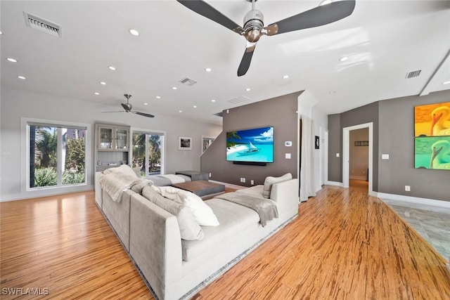 living room with ceiling fan and light hardwood / wood-style floors