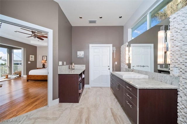 bathroom featuring hardwood / wood-style flooring, ceiling fan, and vanity