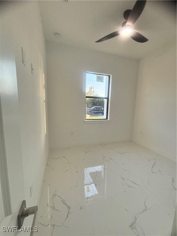 1115 Cumming St E, Lehigh Acres, FL 33974 - spare room with marble look tiles and ceiling fan