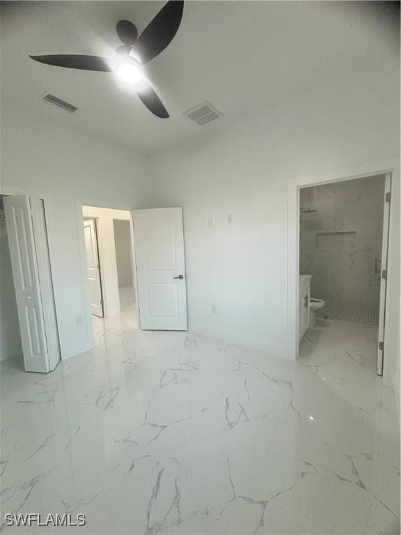 1115 Cumming St E, Lehigh Acres, FL 33974 - unfurnished bedroom featuring light marble finish floors, connected bathroom, and a ceiling fan