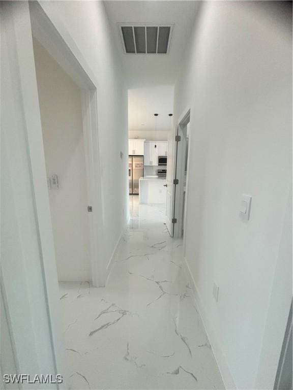 1115 Cumming St E, Lehigh Acres, FL 33974 - corridor with baseboards and light marble finish flooring