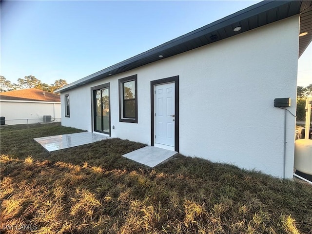 1115 Cumming St E, Lehigh Acres, FL 33974 - rear view of property with stucco siding