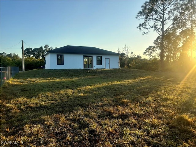 rear view of property with a lawn